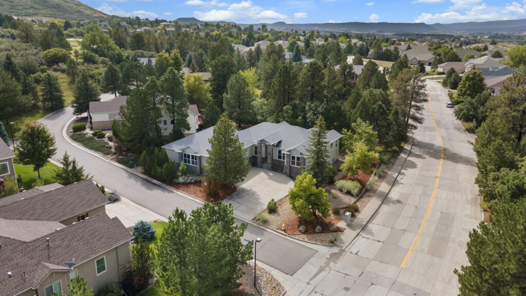 Aerial photography capturing a luxury Castle Rock real estate listing sitting on a corner lot.