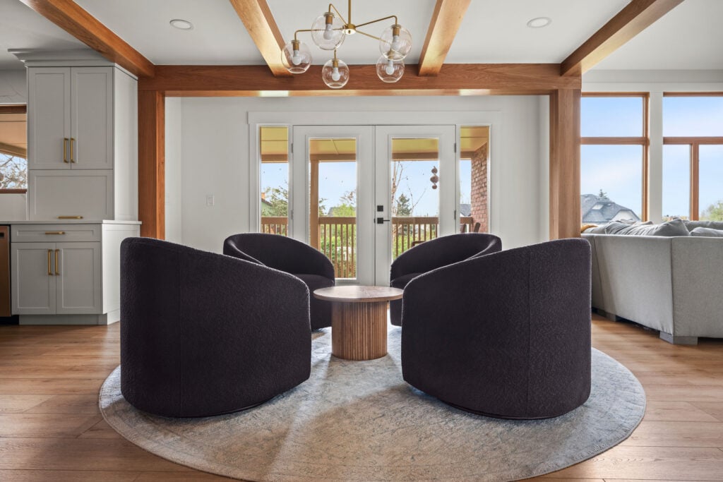 Four dark curved lounge chairs beside an open living room